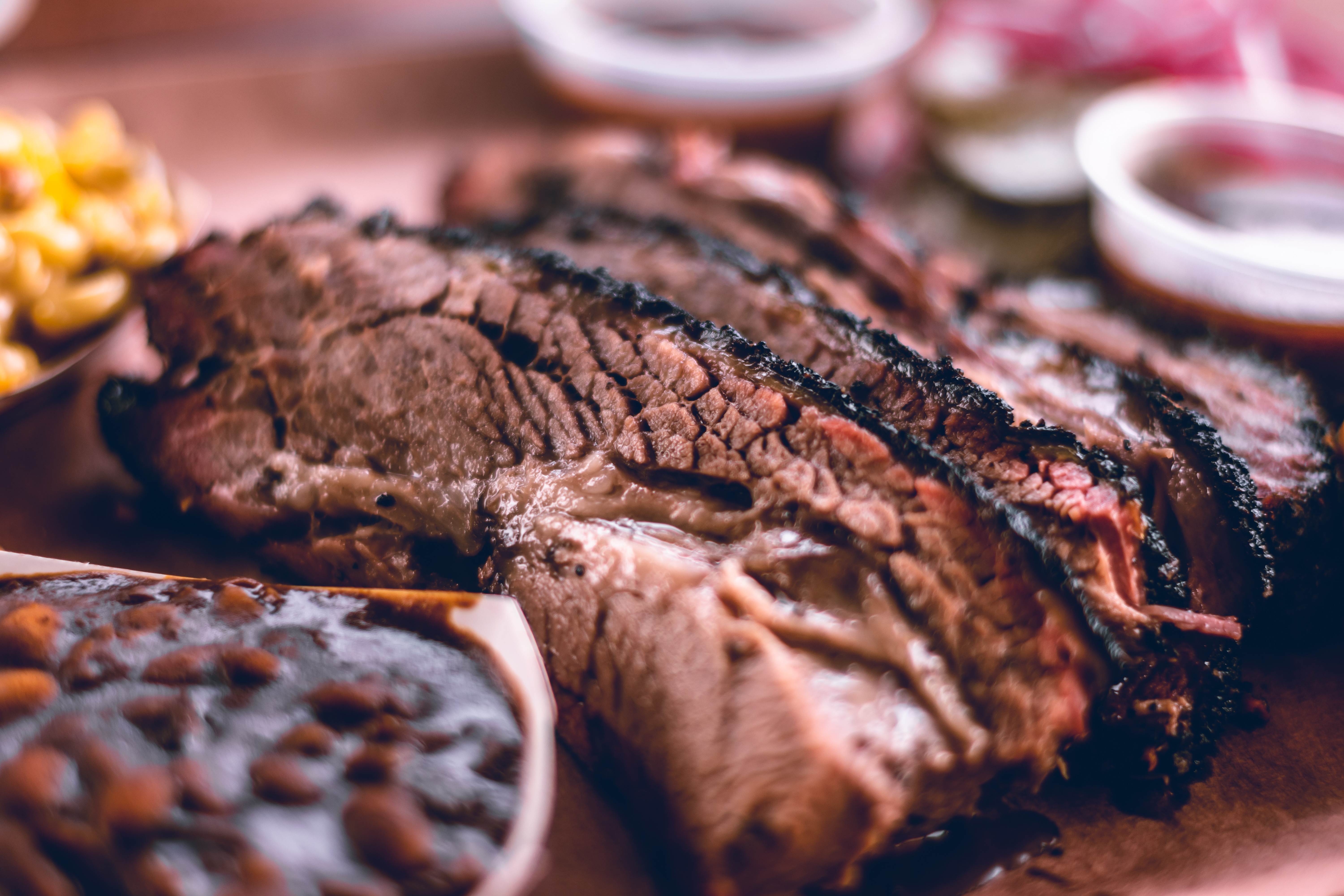 Close-up smoked brisket slices with sides