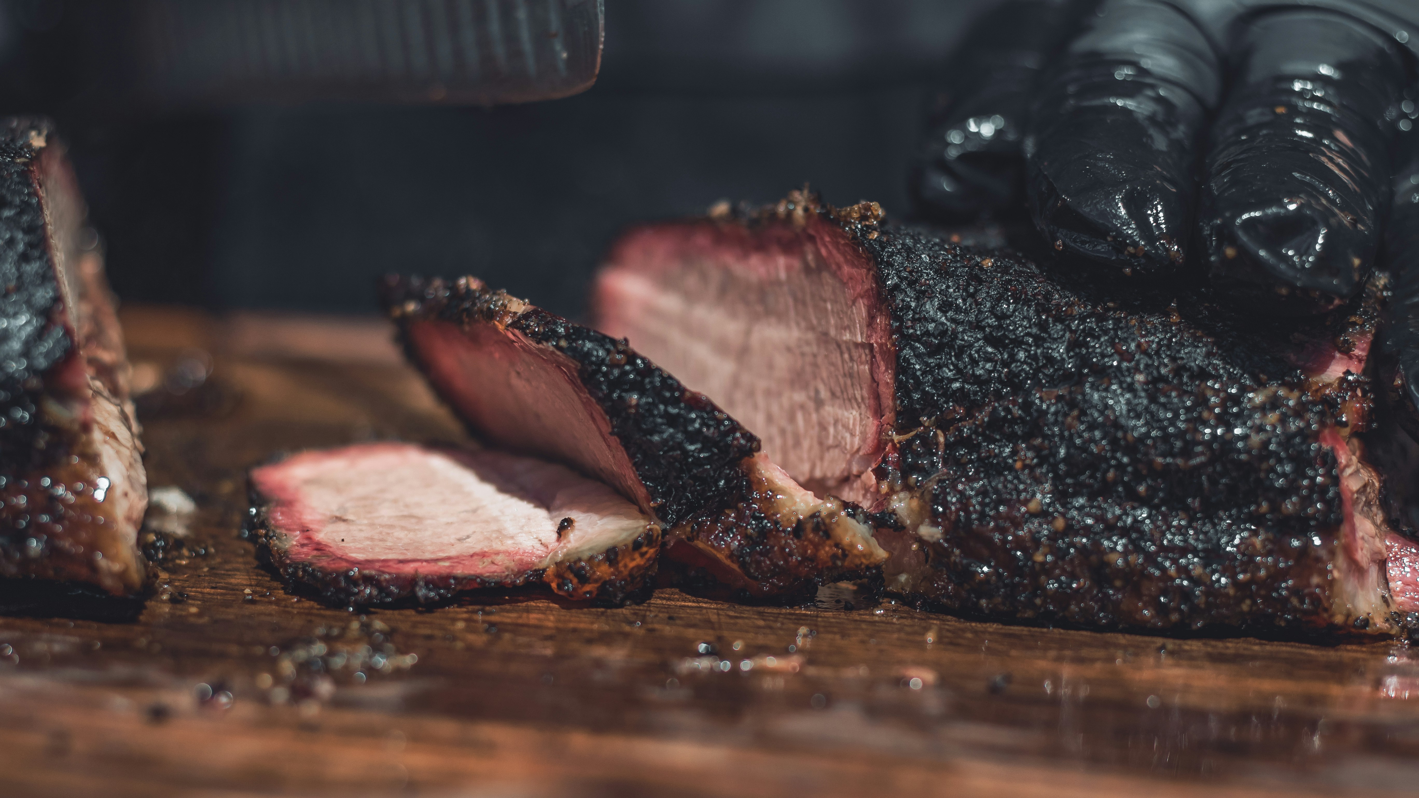 Juicy smoked brisket slices being cut